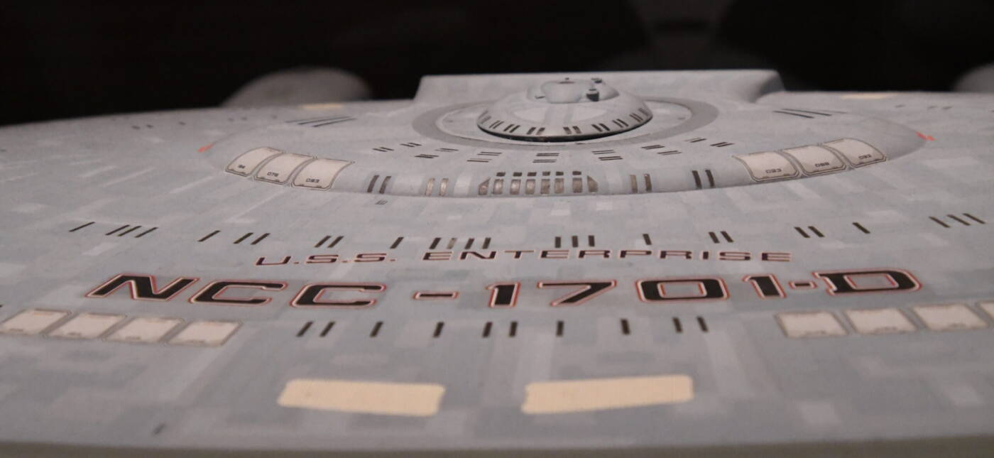 This model of the USS Enterprise star ship NCC-1701-D was used in The Next Generation from 1987-1994. This filming miniature was about 5 feet long! During the summer of 2019, the traveling exhibit "Star Trek: Exploring New Worlds" exhibit was featured at the Henry Ford Museum in Dearborn, Michigan. This is a photo of one of the Star Trek - The Next Generation displays. Taken in August, 2019, near the end of the exhbit's run.