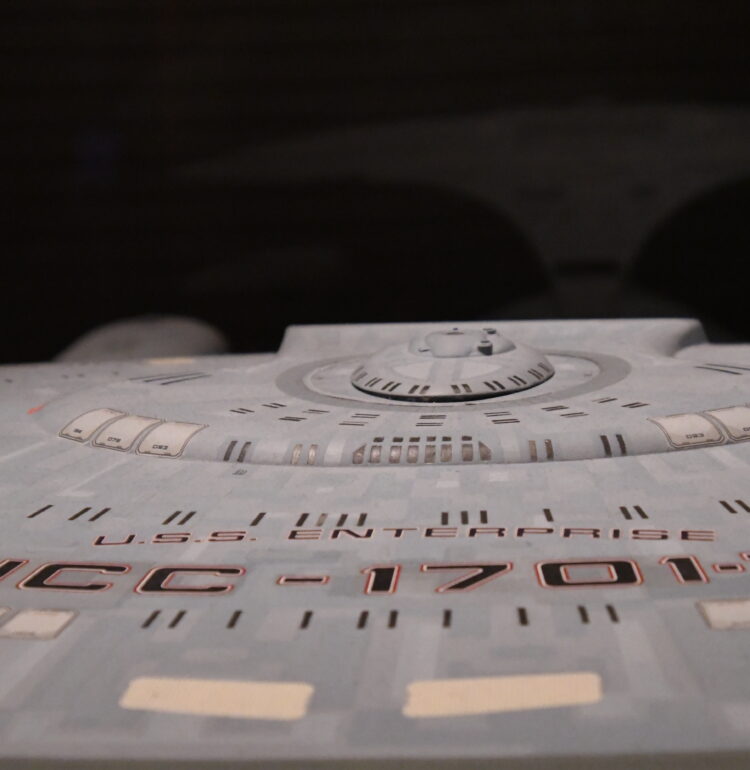 This model of the USS Enterprise star ship NCC-1701-D was used in The Next Generation from 1987-1994. This filming miniature was about 5 feet long! During the summer of 2019, the traveling exhibit "Star Trek: Exploring New Worlds" exhibit was featured at the Henry Ford Museum in Dearborn, Michigan. This is a photo of one of the Star Trek - The Next Generation displays. Taken in August, 2019, near the end of the exhbit's run.