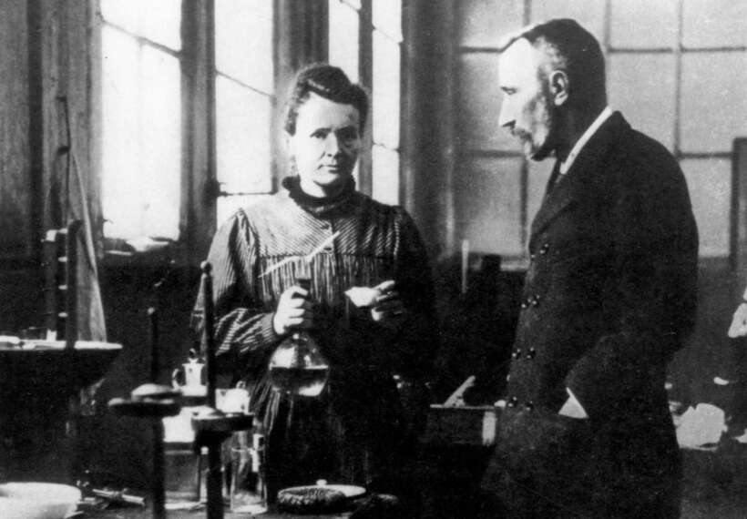 Husband and wife team Marie and Pierre Curie converse in their laboratory.