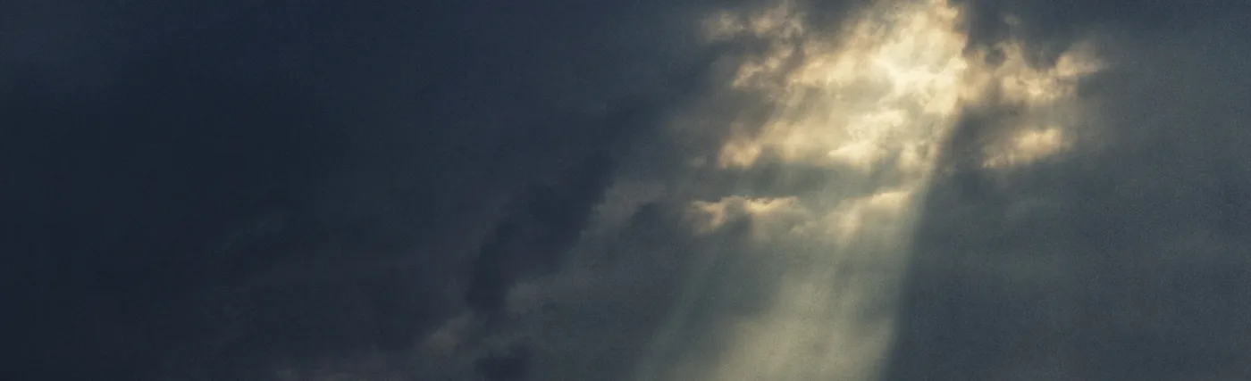 The warm light of the Sun punches through the darkness of the Storm.