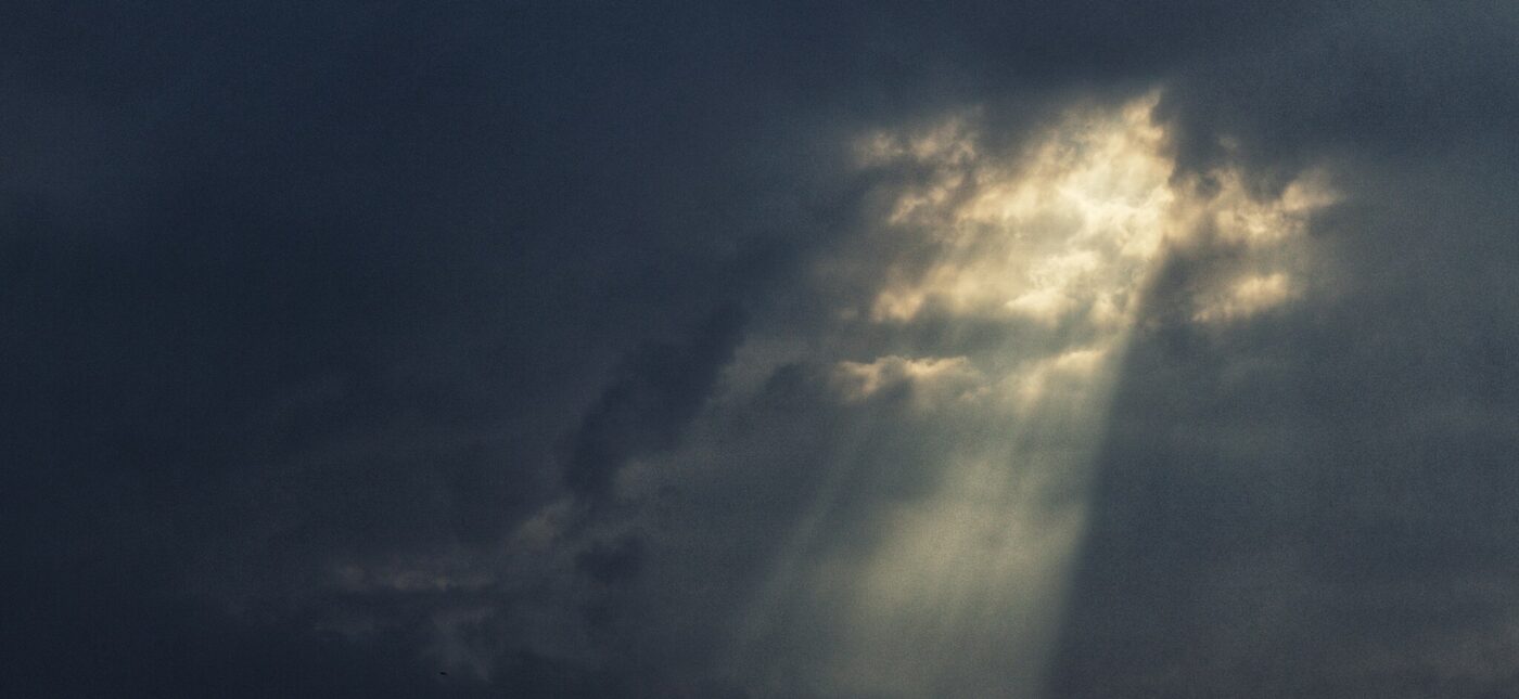 The warm light of the Sun punches through the darkness of the Storm.