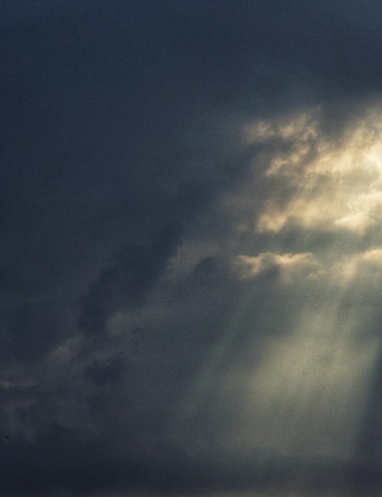 The warm light of the Sun punches through the darkness of the Storm.