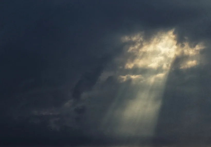 The warm light of the Sun punches through the darkness of the Storm.