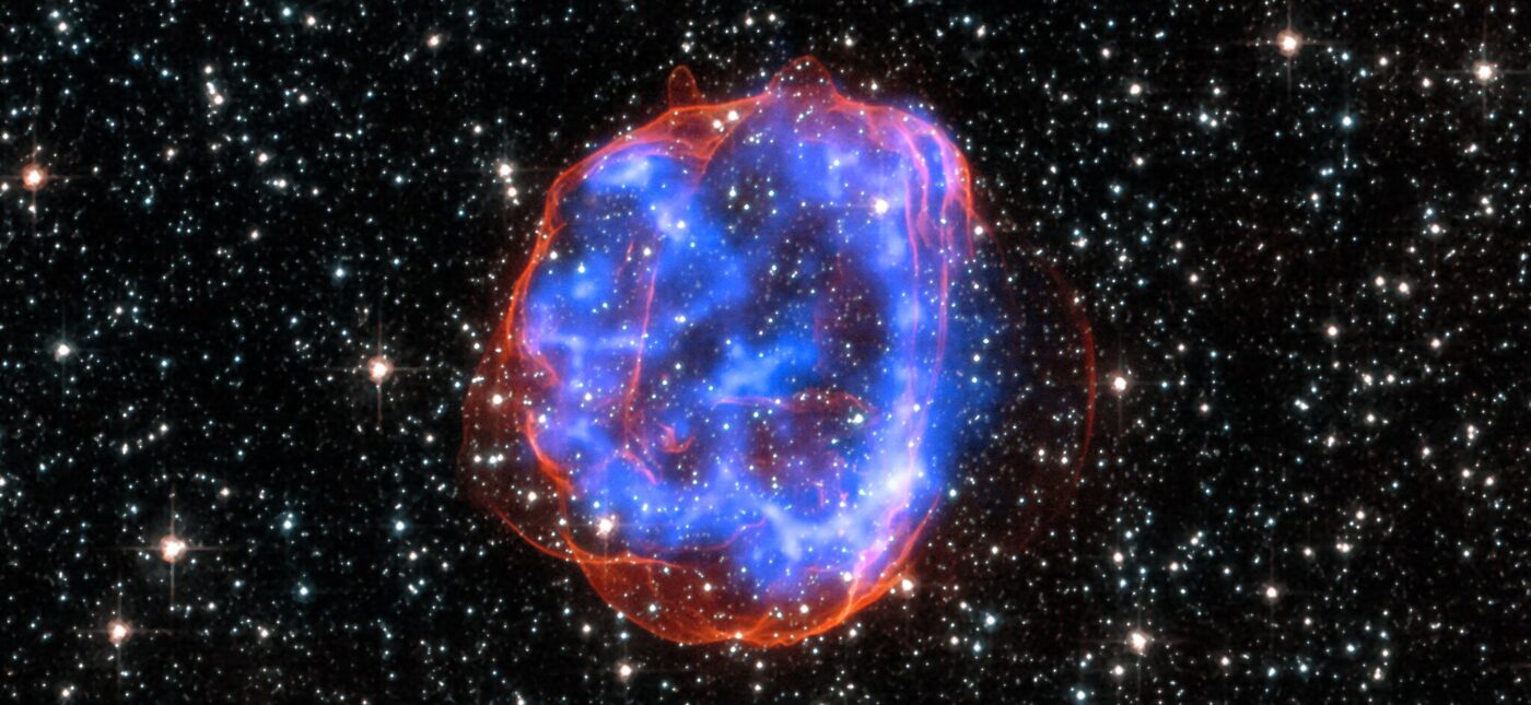 X-ray & Optical Images of SNR E0519-69.0 - When a massive star exploded in the Large Magellanic Cloud, a satellite galaxy to the Milky Way, it left behind an expanding shell of debris called SNR 0519-69.0. Here, multimillion degree gas is seen in X-rays from Chandra (blue). The outer edge of the explosion (red) and stars in the field of view are seen in visible light from Hubble.