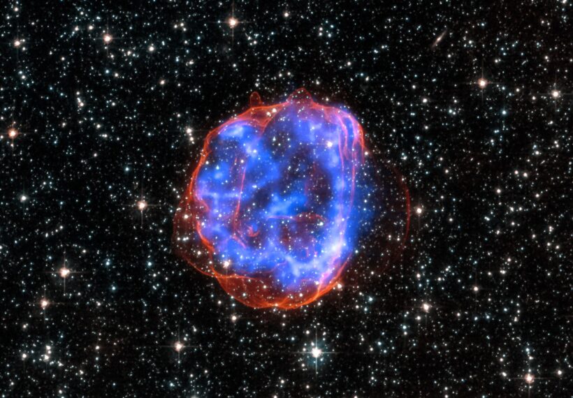 X-ray & Optical Images of SNR E0519-69.0 - When a massive star exploded in the Large Magellanic Cloud, a satellite galaxy to the Milky Way, it left behind an expanding shell of debris called SNR 0519-69.0. Here, multimillion degree gas is seen in X-rays from Chandra (blue). The outer edge of the explosion (red) and stars in the field of view are seen in visible light from Hubble.