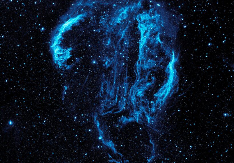 Wispy tendrils of hot dust and gas glow brightly in this ultraviolet image of the Cygnus Loop Nebula, taken by NASA’s Galaxy Evolution Explorer.
