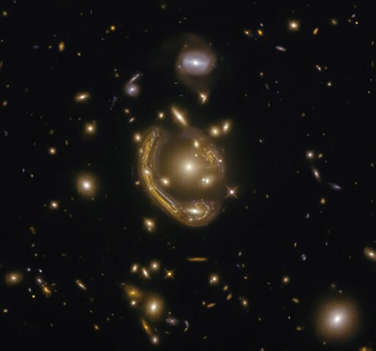 The narrow galaxy elegantly curving around its spherical companion in this image is a fantastic example of a truly strange and very rare phenomenon.