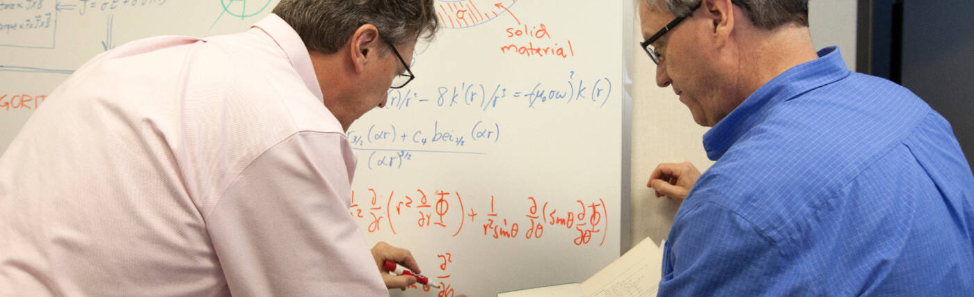 Physicists work on an equation