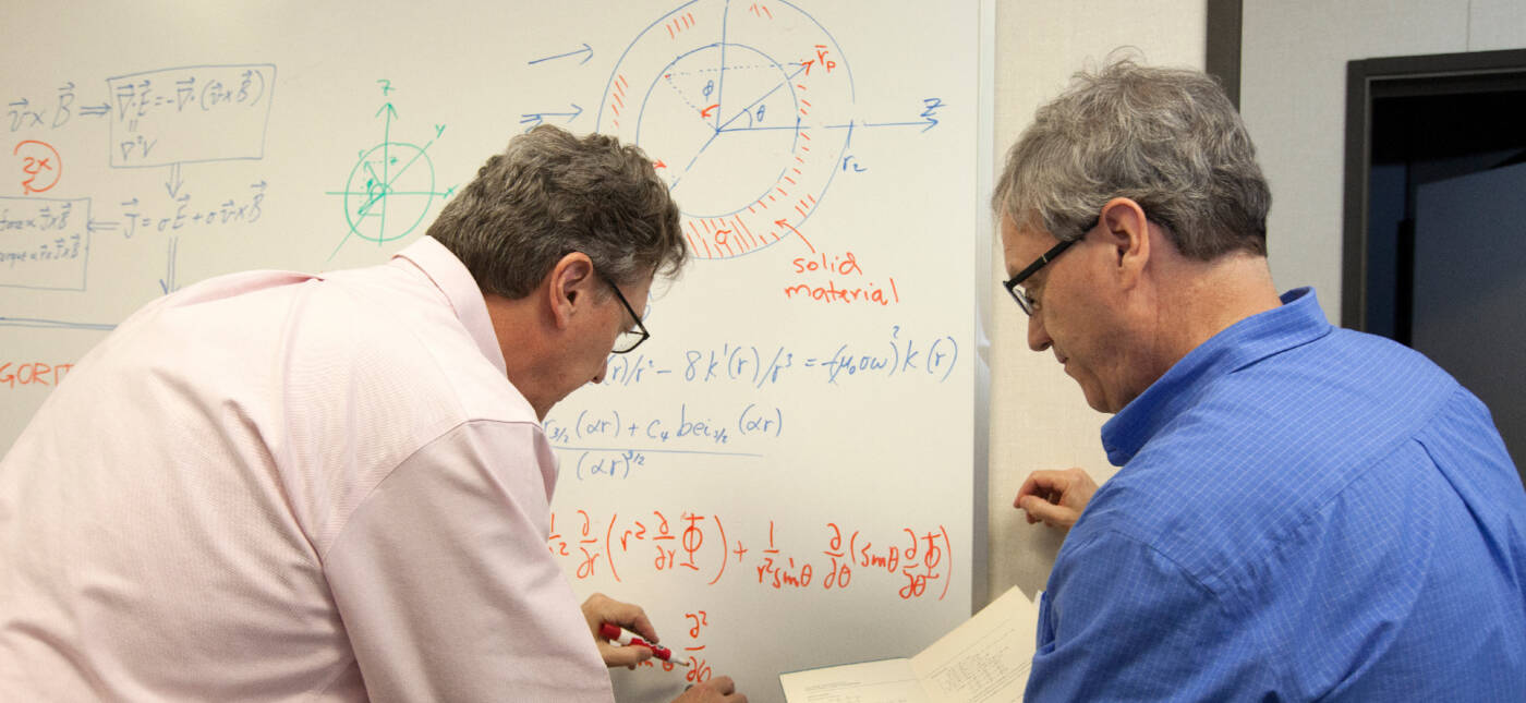 Physicists work on an equation