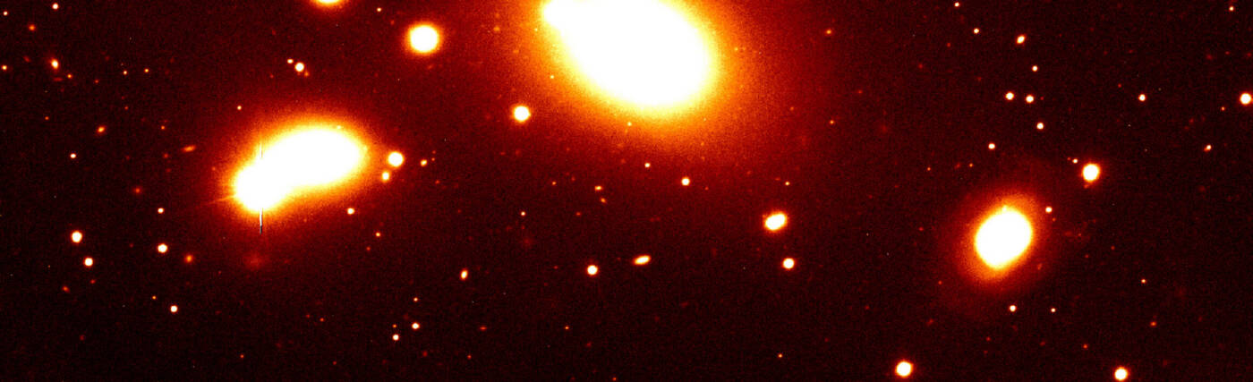 Nearby galaxy group RXCJ0937.9-2020 at a redshift of z = 0.034. It is dominated by the massive elliptical galaxy seen at the top of the image. The photo covers only the southern part of this group. Such galaxy groups with typical masses of a few 1013 solar masses constitute the smallest objects included in the REFLEX catalogue. This image was obtained with the FORS1 multi-mode instrument on the ESO 8.2-m VLT Antu telescope.