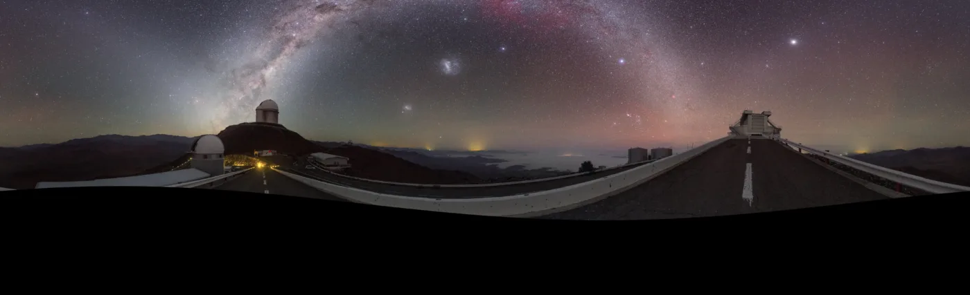 This striking image was captured using a fish-eye lens, giving it the distinctive look of a circular window, peering into a different world. Here the landscape at the [/public/teles-instr/lasilla/ La Silla] observatory in Chile can be seen wrapped around the edge, with the constellations of the Zodiac splashed across the early morning sky.