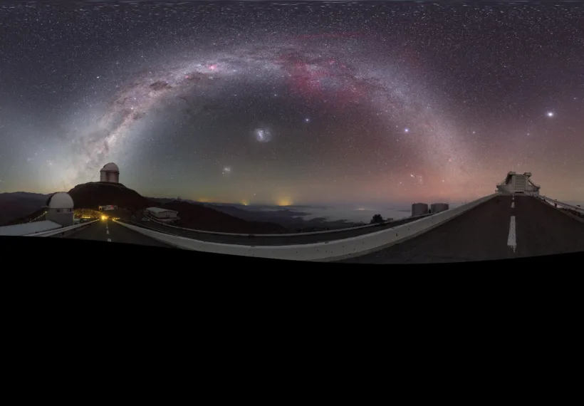 This striking image was captured using a fish-eye lens, giving it the distinctive look of a circular window, peering into a different world. Here the landscape at the [/public/teles-instr/lasilla/ La Silla] observatory in Chile can be seen wrapped around the edge, with the constellations of the Zodiac splashed across the early morning sky.