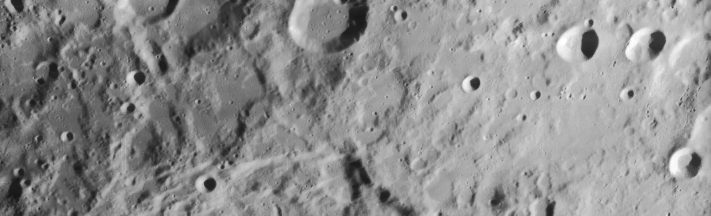 Slightly oblique view of most of craters Clavius and Maginus, on the moon. North is to upper right.