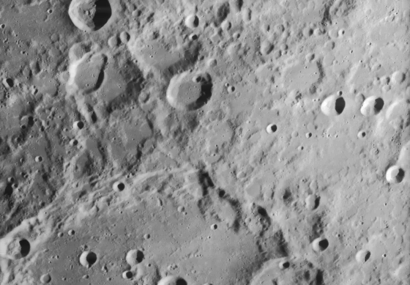 Slightly oblique view of most of craters Clavius and Maginus, on the moon. North is to upper right.