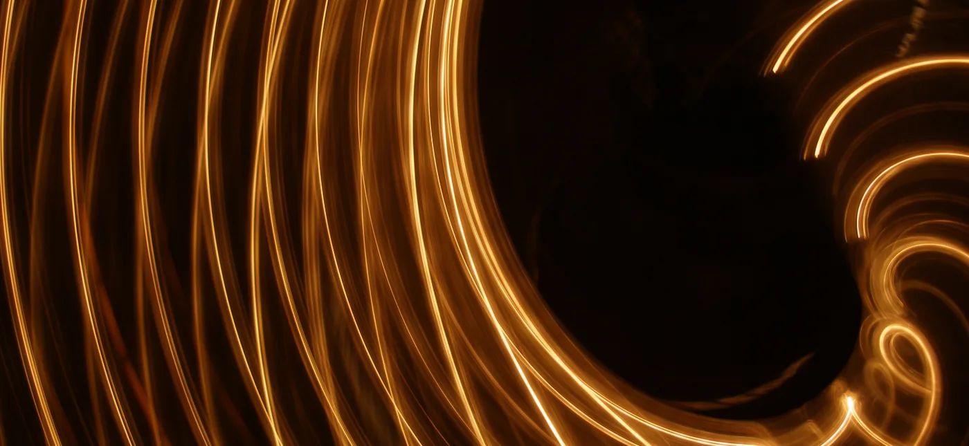 Camera toss-up in front of a string of Christmas lights