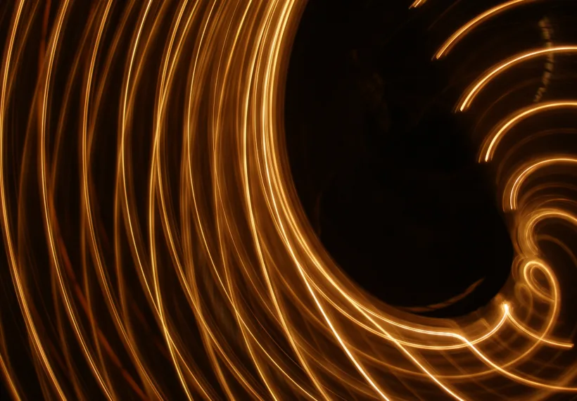 Camera toss-up in front of a string of Christmas lights